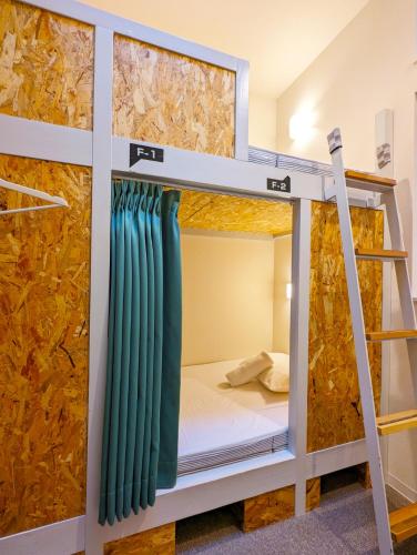 a bunk bed in a hostel with a bunk bed in a room at KIZUNA HOTEL Gojo Kiyomizu-dera Kamogawa in Kyoto