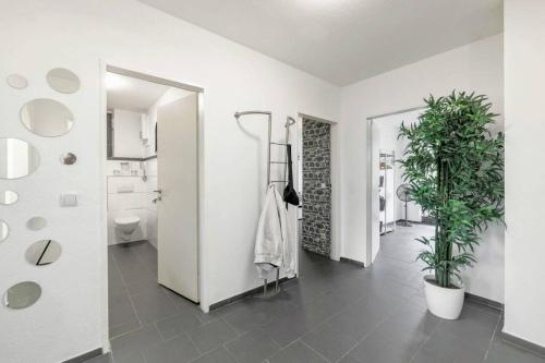 a bathroom with a toilet and two potted plants at Top Equipped Netflix WLAN Landschaftspark in Duisburg