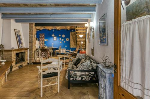 a living room with a couch and chairs and a fireplace at Casa Blava in Orriols