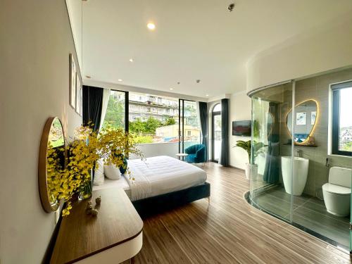 a bedroom with a bed and a bathroom with a mirror at Memory Inn - Valley View in Xuan An