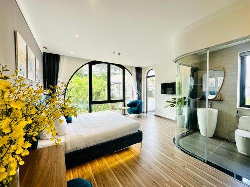 a bedroom with a bed and a glass wall at Memory Inn - Valley View in Xuan An
