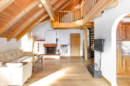 a living room with a couch and a fireplace at Villa Ortensia in San Vigilio Di Marebbe