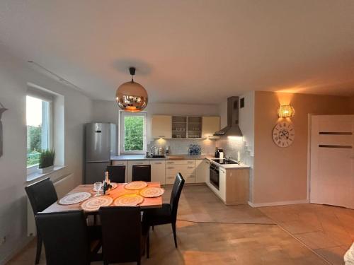 a kitchen with a table and chairs in a kitchen at Przestronny apartament in Gdańsk