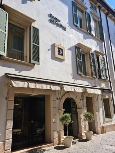 a building with a clock on the side of it at Palazzo Ai Capitani in Peschiera del Garda