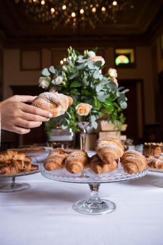 a person holding a plate of pastries on a table at Grand Hotel Telese in Telese