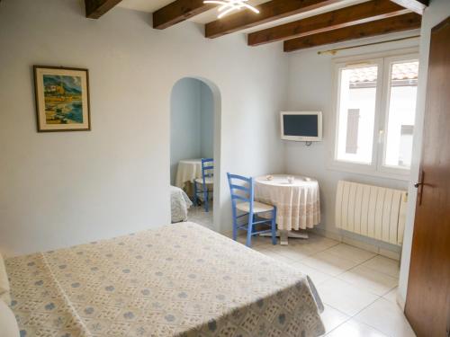 a bedroom with a bed and a table and a window at Maison Villa Yoda in Saint-Jean-de-Luz