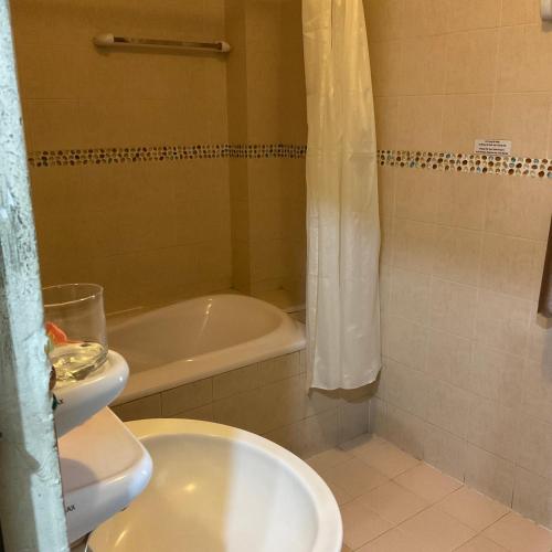 a bathroom with a toilet and a tub and a sink at Khách sạn Minh Châu - Hòa Hưng in Ho Chi Minh City