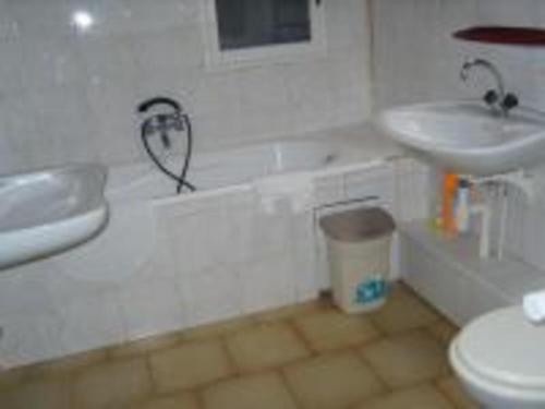 a bathroom with a sink and a tub and a toilet at les Oiseaux - Pinède avec piscine in Argelès-sur-Mer
