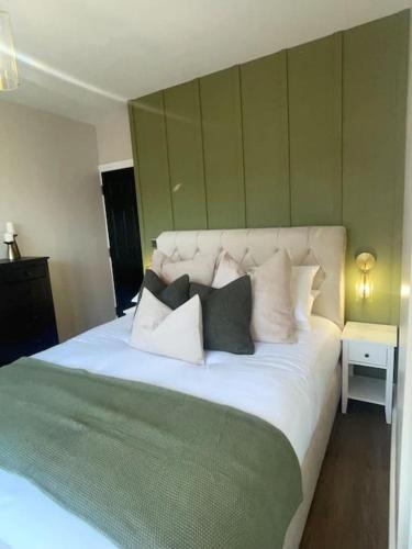 Un dormitorio con una gran cama blanca con almohadas. en Churchview Apartments, en Seaham