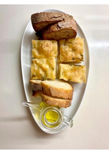 a white plate with bread and a tablespoon of mustard at Alle Pendici del Conero in Sirolo