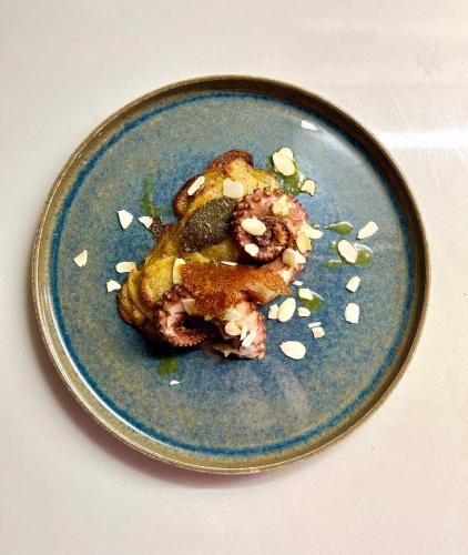 a blue plate with a piece of food on it at Alle Pendici del Conero in Sirolo