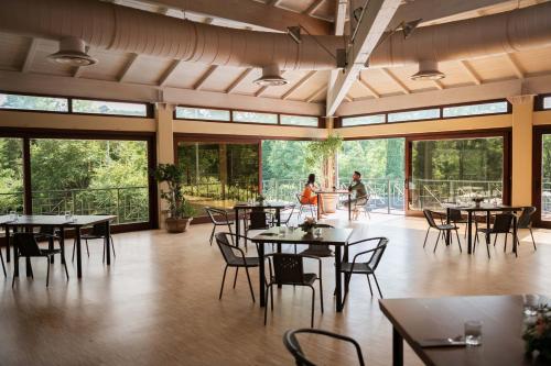 a restaurant with tables and chairs and people in the background at Grand Hotel Telese in Telese