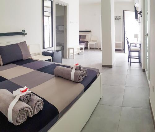 a bedroom with a bed with towels on it at Punto Blu Relax in Agropoli