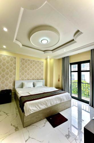 a bedroom with a large bed in a room at RUBY HOTEL in Tây Ninh