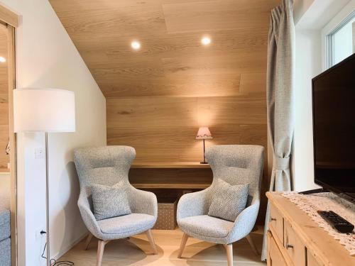 two chairs in a room with a desk and a lamp at Eurochalet in Campitello di Fassa