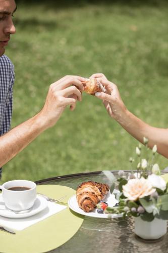 two people eating food at a table with a cup of coffee at Grand Hotel Telese in Telese