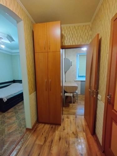 a room with a closet and a bedroom with a bed at Жилье в Кропивницком in Kropyvnytskyi