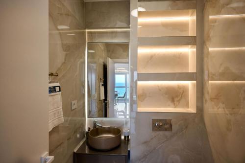 a bathroom with a sink and a mirror at Beach Bliss Apartment in Infinity Beach Resort parking in Mamaia