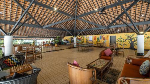 a large room with chairs and tables and a ceiling at Novotel Goa Dona Sylvia Resort in Cavelossim