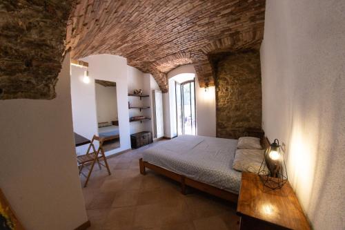 a bedroom with a bed and a table in a room at Officine Bordighera in Bordighera