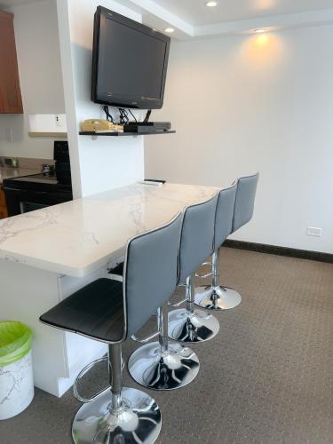 a conference room with a table with chairs and a tv at One-Bedroom Apartment in Honolulu