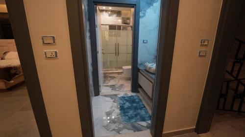 a bathroom with a glass door with a shower and a toilet at ايله - Aylah 