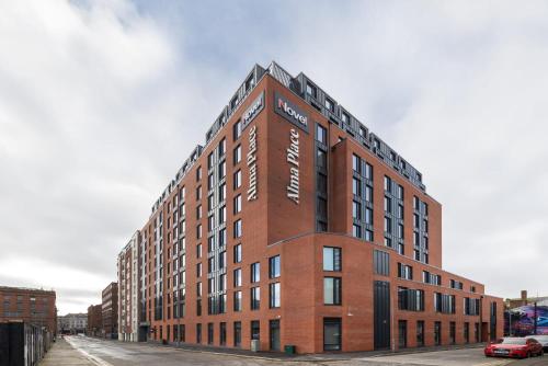 a large red brick building on a city street at For Students Only Fresh Alma Place Belfast in Belfast