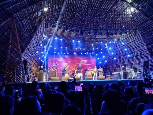 a stage with a group of people on a show at Encamp Ziro Valley Camp in Hāpoli