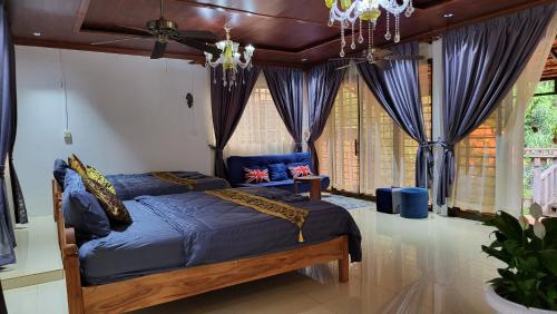 a bedroom with two beds and a ceiling fan at CL Homestay in Senmonorom