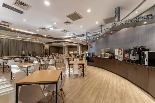 a restaurant with tables and chairs and a bar at Hotel j-Metropolis in Hsinchu City