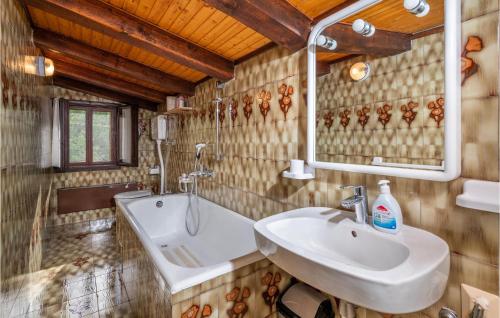 a bathroom with a sink and a tub at Cozy Home In Plomin With Kitchen in Plomin