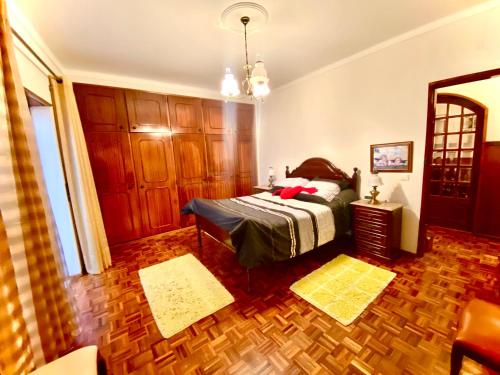 a bedroom with a bed and a wooden floor at Spray B&B Sitio in Nazare, European style in Nazaré