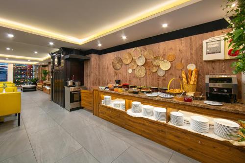 a restaurant with a counter with plates on it at San Hanoi Hotel in Hanoi