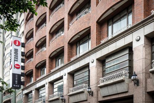 a brick building with balconies on the side of it at Hotel j-Metropolis in Hsinchu City