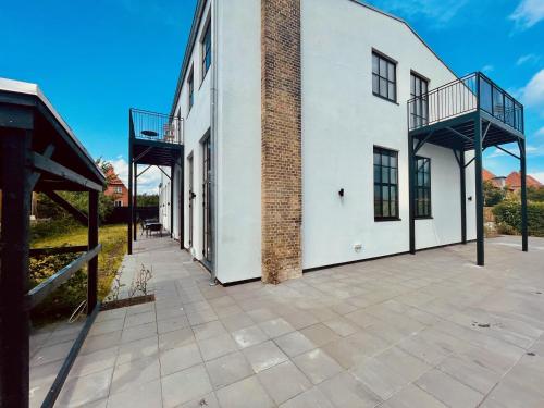 an empty courtyard of a white building at Cozy and Bright Apartments with Private Car Park in Copenhagen