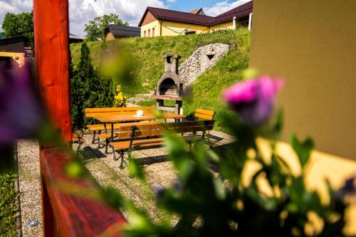 a group of benches and a hill with a house at Chata Alex Liptov in Trstené