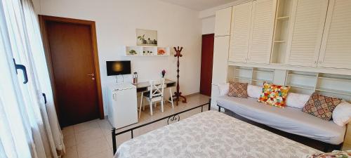 a living room with a couch and a table at Le Terrazze Rooms & Studios in Ferrara