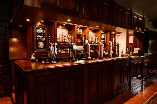 a bar in a pub with a lot of alcohol at The Exchange Hotel in Brigg