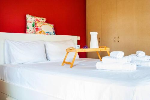 a bed with towels and a table on it at Spacious and Modern Apt in the Suburbs of Athens in Athens