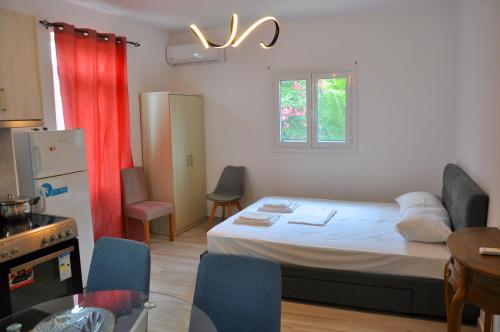a small room with a bed and a kitchen at Dimitra Apartments in Sitia