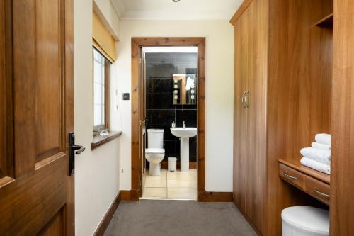 a bathroom with a toilet and a sink at Achnagairn Estate - Self-catering Mini Manors in Beauly