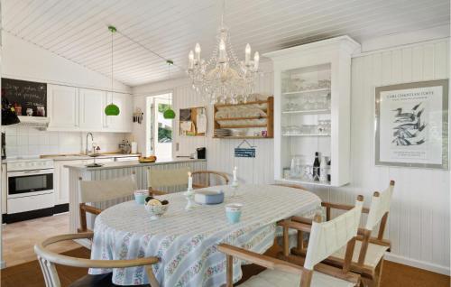 a kitchen and dining room with a table and chairs at Beautiful Home In Sejerø With Kitchen in Sejerby