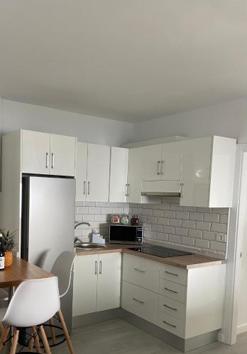 a kitchen with white cabinets and a white refrigerator at Las Vistas in Frontera