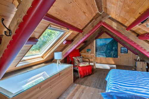 a bedroom of a tiny house with a tub at Finest Retreats - The Watchtower at Western Watch in Lower Boscaswell