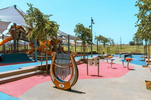 a park with a playground with a slide at חופים מול הים in Bat Yam