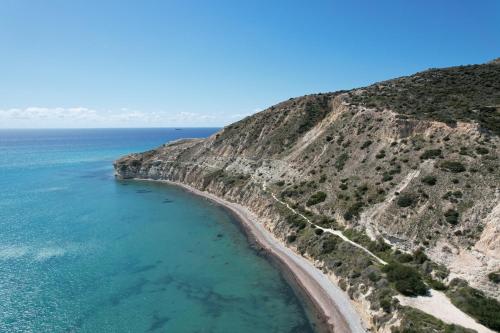 an aerial view of a beach and the ocean at Pissouri bay studio in Pissouri