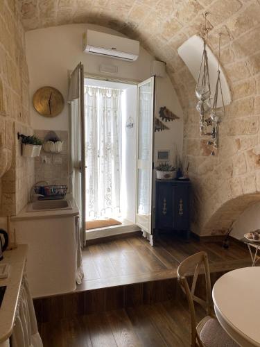a kitchen with a large window and a table at Casa Rebecca 14 in Monopoli