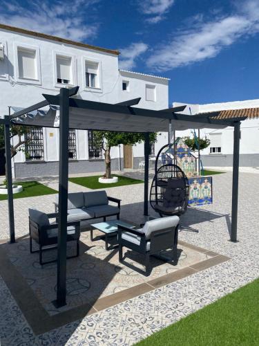 a picnic shelter with benches and a swing at Convento Hermana Esther in Alosno