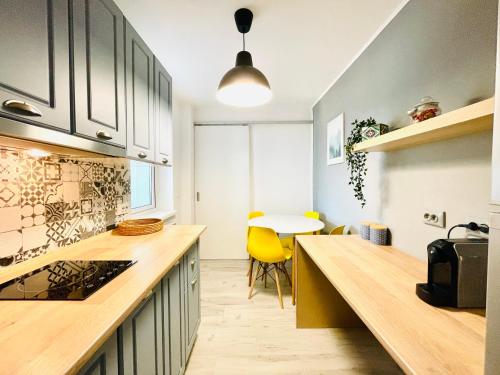 a kitchen with a counter top and a table at Studio F13 in Topliţa