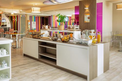 a kitchen with a counter with fruit on it at ibis Styles Les Sables Olonne in Les Sables-dʼOlonne